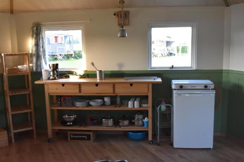 a kitchen with a counter and a sink and a stove at 't Peelhuisje in Kronenberg