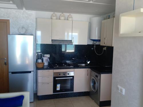 a kitchen with a stove and a refrigerator at Mahdia beach in Kenitra