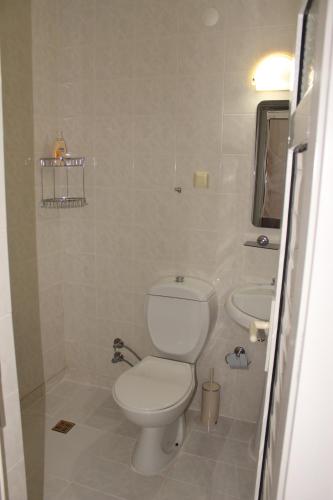 a bathroom with a toilet and a sink at Patara Caretta Hotel in Patara