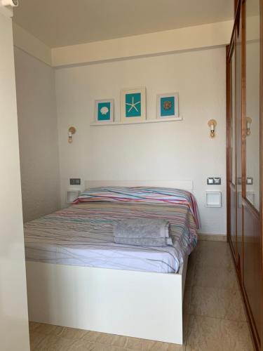 a small bedroom with a bed in a room at Apartamento primera línea de Mar Enjoy the view in Blanes