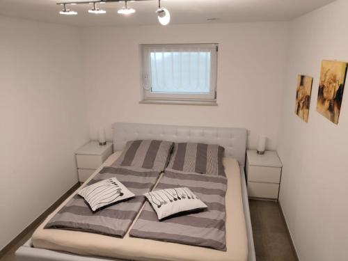 a bedroom with a bed with two pillows on it at Taunusrast-Usi in Usingen