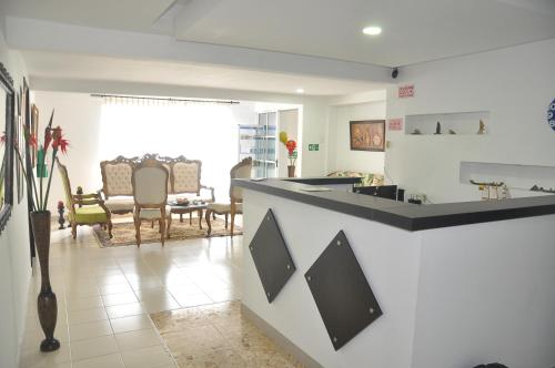a kitchen with a counter and a dining room at Casa Hotel Manga Mar in Cartagena de Indias