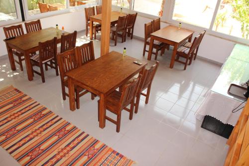 a dining room with wooden tables and chairs at Patara Caretta Hotel in Patara