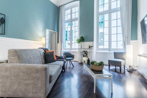 a living room with a couch and a table at Family Apartments San Lorenzo in Genova