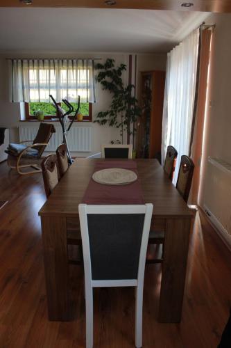 a dining room with a wooden table and chairs at Ubytování v Kamenném zákoutí in Česká Ves