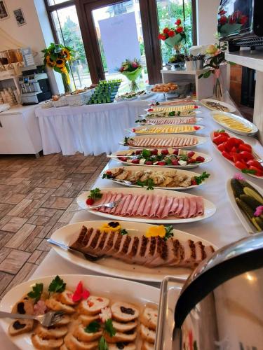 a buffet line with many plates of food at PIONOW Pokoje WaWa - adults only in Krynica Morska