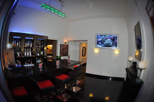a bar with red stools in a room at Budget Hotel Le Beau Rivage in Middelburg