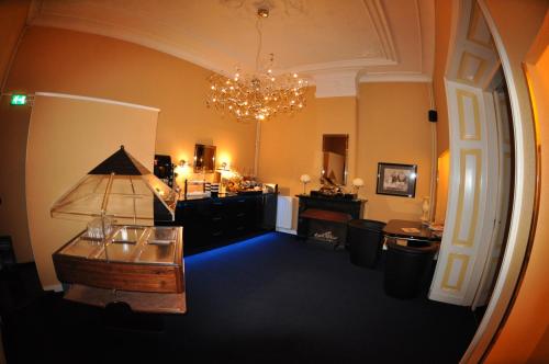 a large room with a chandelier and a table in it at Budget Hotel Le Beau Rivage in Middelburg