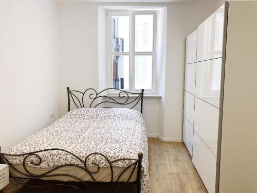 a bedroom with a bed and a window at Apartment Mario in Piran