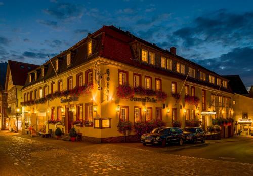 a building on a street with cars parked in front of it at Hotel Garni "Brauerei Keller" in Miltenberg
