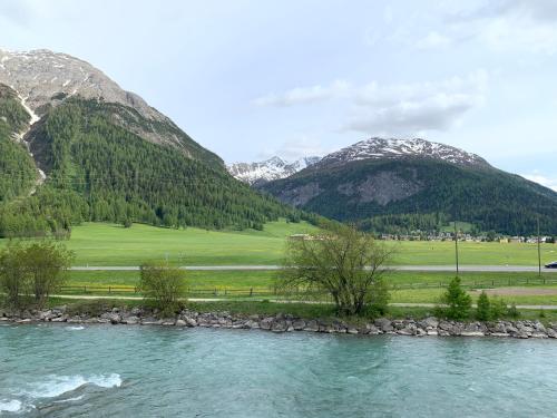 a river with mountains in the background at Madulain Lodge @ Werkhof in Madulain