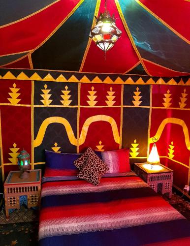 a room with a bed in a circus tent at Maison d'hôtes Cité Portugaise in El Jadida