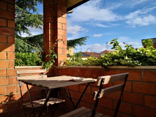 a wooden table and chairs sitting on a patio at Zia Chiarina in San Nicolò Gerrei