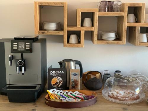 a kitchen counter with a coffee maker and plates on a shelf at Agroturismo Llucasaldent Gran Menorca - Adults Only in Son Bou