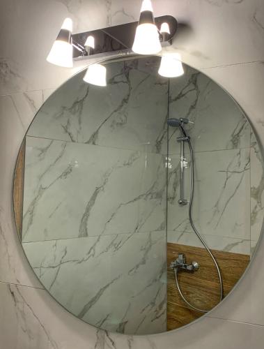 a bathroom with a large mirror with a shower at Petite Luxury Urban House in Tríkala