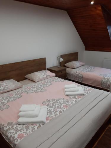 a bedroom with two beds with towels on them at Maison ALANA in Divčibare