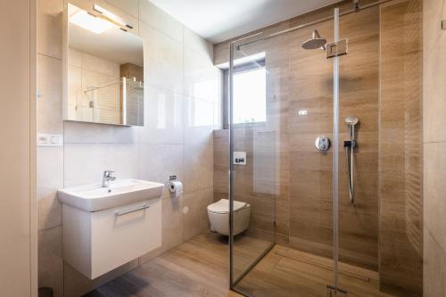 a bathroom with a shower and a toilet and a sink at Horská Chata Ostružiny in Donovaly