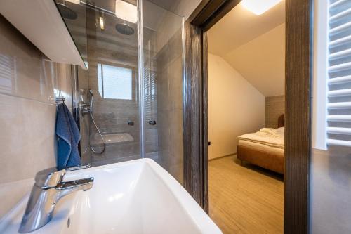 a bathroom with a sink and a shower at Horská Chata Ostružiny in Donovaly