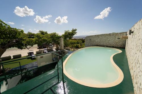a swimming pool on the roof of a house at Camagna Country House in Santa Ninfa