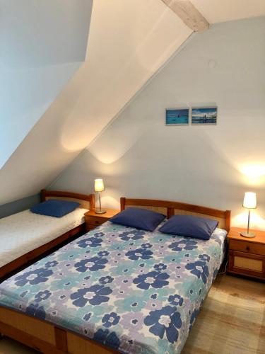 a bedroom with two beds and two lamps at Sianki nad Sanem in Sanok