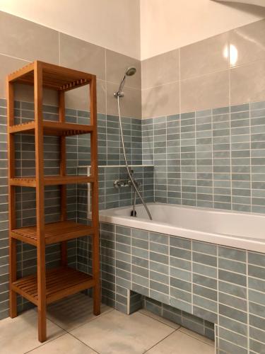 a bathroom with a bath tub with blue tiles at Sianki nad Sanem in Sanok
