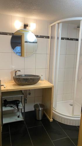 a bathroom with a sink and a mirror and a shower at Haus Helli in Berwang