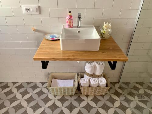 a bathroom with a sink and a counter with towels at LA MOMA Apartments & Room in Xàtiva