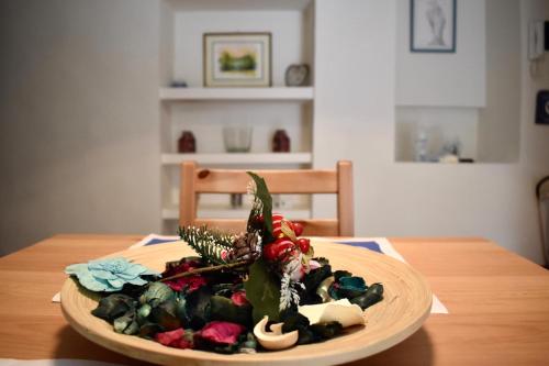 a plate of food on a wooden table at Suali Case nel Borgo in Civita Castellana