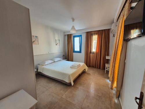 a bedroom with a bed in a room at Finiki Villas in Foinikion