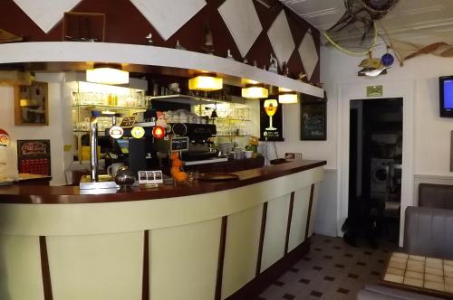 a bar in a restaurant with a counter at L'Ex-Voto in Honfleur