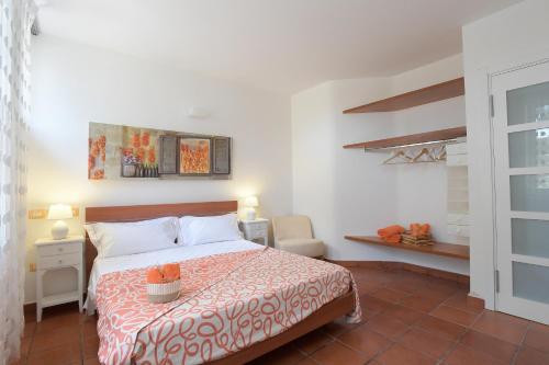 a bedroom with a bed and a chair and a window at Bio&B Acquaviva in Otranto