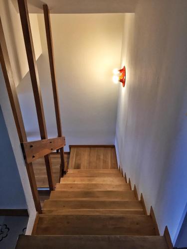 a set of stairs with a light on the wall at Panoramic Apartment Poggettone Air conditioned in Punta Ala