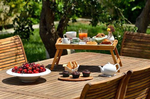 a table with a tray of food on a wooden table at Bio&B Acquaviva in Otranto