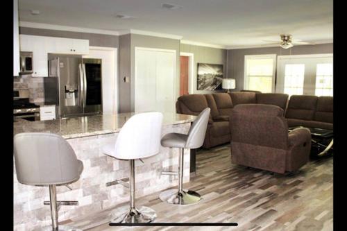 a living room with a couch and a table and chairs at CYC Lounge with Guest House in San Antonio
