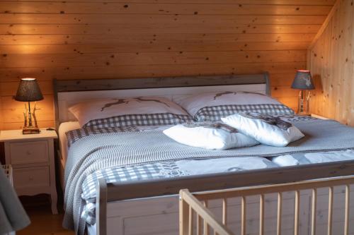 a bedroom with a bed with two deer on the pillows at Kogljahrerhütte in Wolfsberg