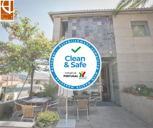 a sign for a clean and safe restaurant in front of a building at Hotel De Cerva in Cerva