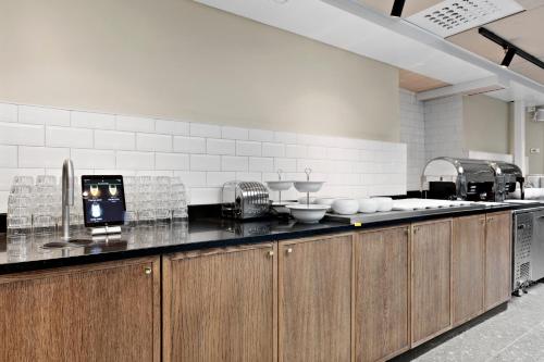 a kitchen with wooden cabinets and a counter top at Best Western Hotel at 108 in Stockholm