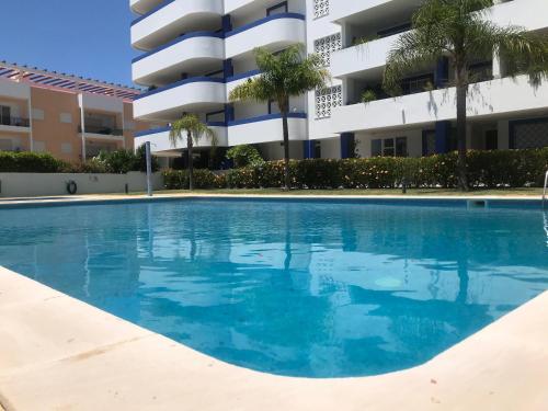 an empty swimming pool in front of a building at Timeless Vacations Vilamoura Marina Flat WIFI & Pool in Vilamoura