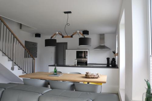 a kitchen and dining room with a table and chairs at Reusenhaus Nord in Breege
