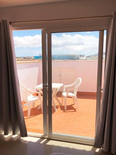 a view of a balcony with a table and chairs at Cotillo Ocean View in Cotillo
