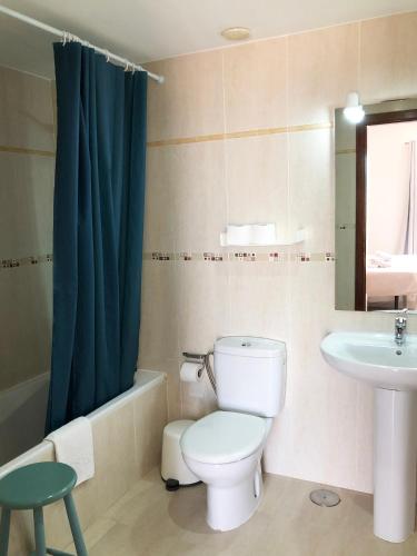 a bathroom with a toilet and a sink at Cotillo Ocean View in Cotillo