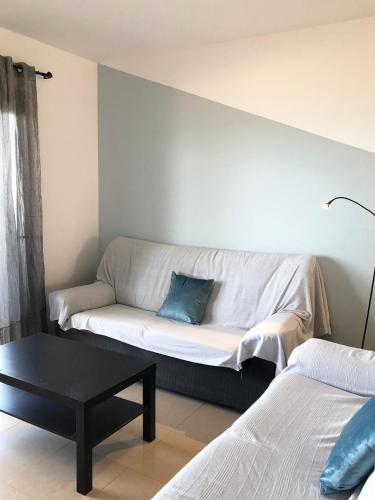 a living room with a couch against a wall at Cotillo Ocean View in Cotillo