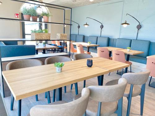 a dining room with tables and chairs in a restaurant at Pilot Airport Hotel in Vantaa