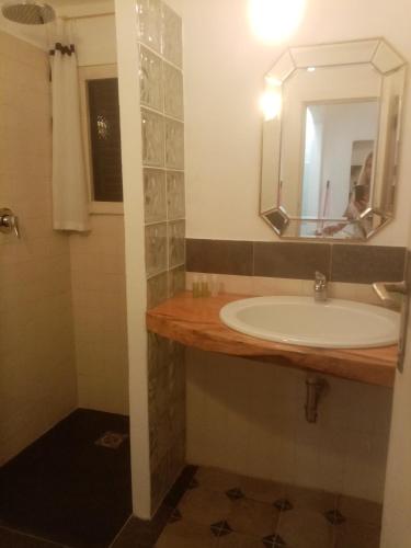 a bathroom with a sink and a mirror at Laetitia in Porto Santo Stefano