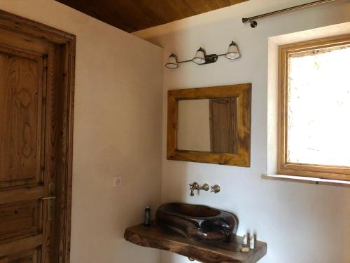 a bathroom with a wooden sink and a mirror at ALZITEDDA in Porto-Vecchio