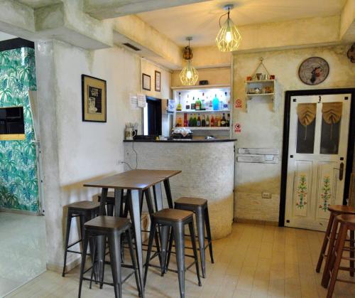 a restaurant with a table and stools in a room at Black Valley House in Gura Humorului