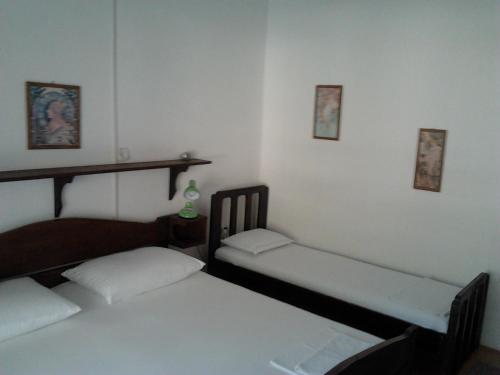 two twin beds in a room with two chairs at Apartments Krpan in Donja Klada