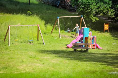 a woman is playing on a playground at Folwark Wierzchy in Wierzchy