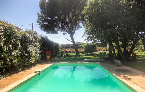 a large swimming pool in a yard with trees at Stunning Home In Caux in Caux