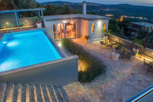 a villa with a swimming pool at night at Apartments Villa Preciosa in Kotor